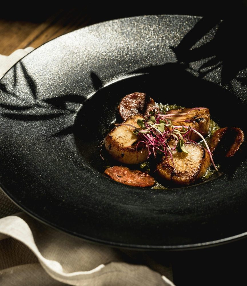 black background with deep dish and mushrooms