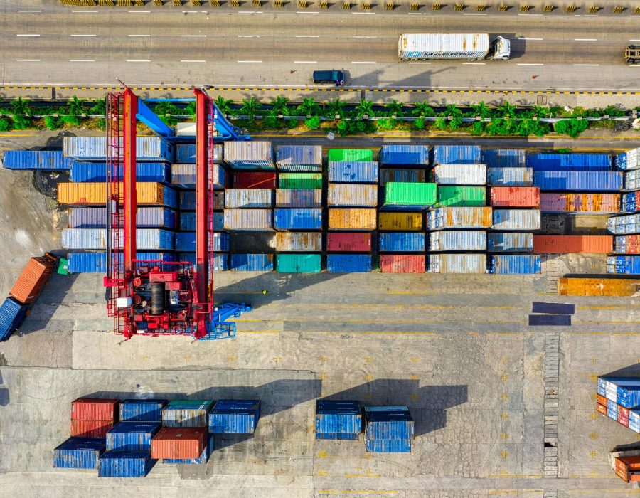 stack of colorful containers handling by crane